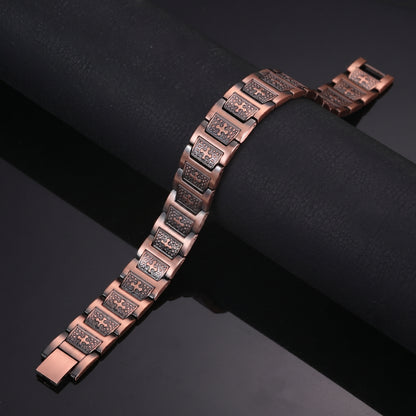 copper Celtic Cross bracelet resting on a black surface, showcasing its distinctive heritage-inspired design.