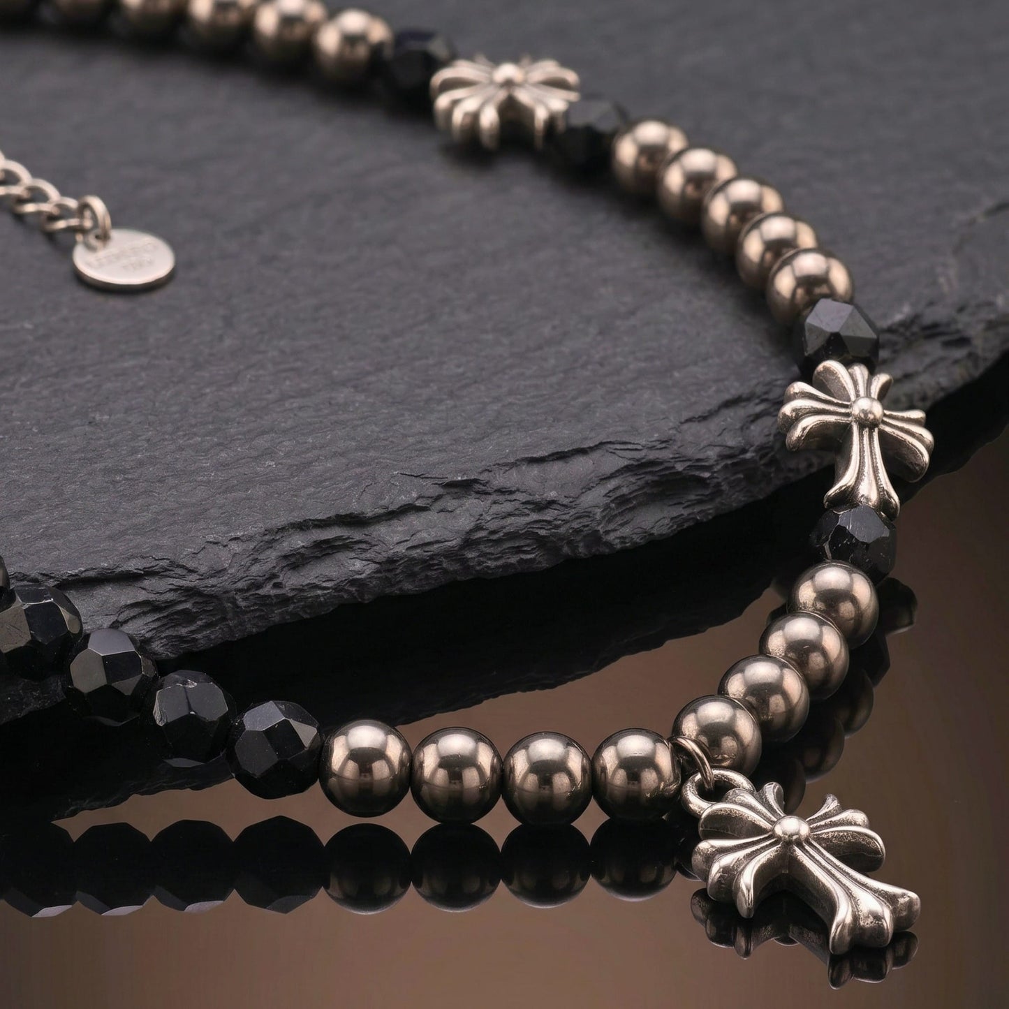 titanium steel cross necklace for men with black beads and decorative cross accents on a dark background