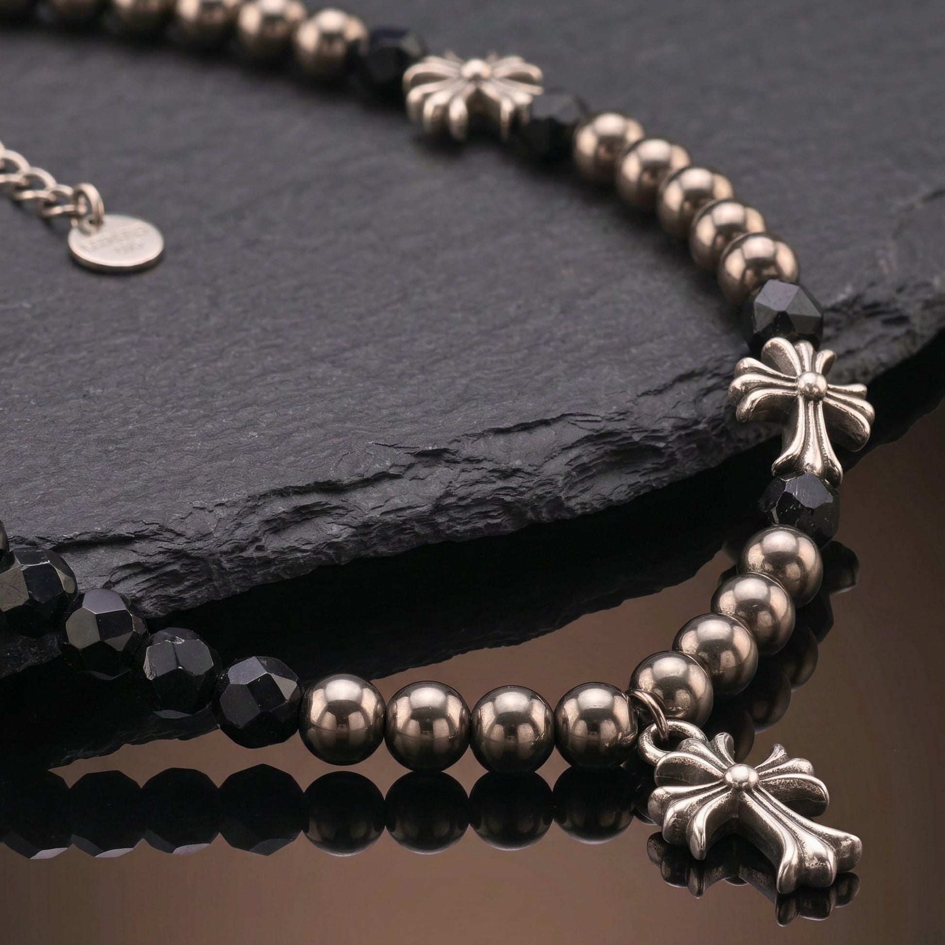 titanium steel cross necklace for men with black beads and decorative cross accents on a dark background