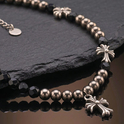 titanium steel cross necklace for men with black beads and decorative cross accents on a dark background