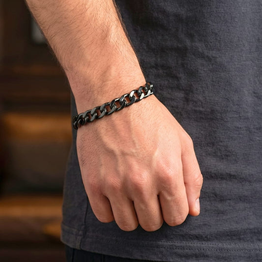 Stainless steel lobster clasp bracelet worn on a male hand, showcasing modern styling and rugged design.